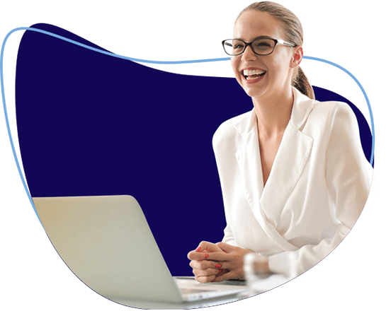 Woman wearing glasses smiling and using a laptop
