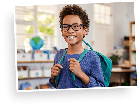 boy with eyeglasses smiling ready for school