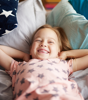 Girl happy while lying at bed
